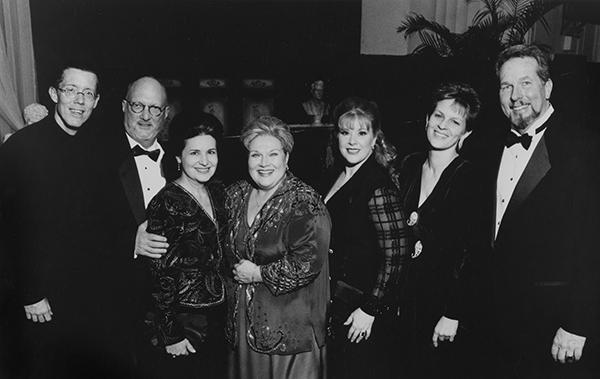 a group of men and women in formal attire